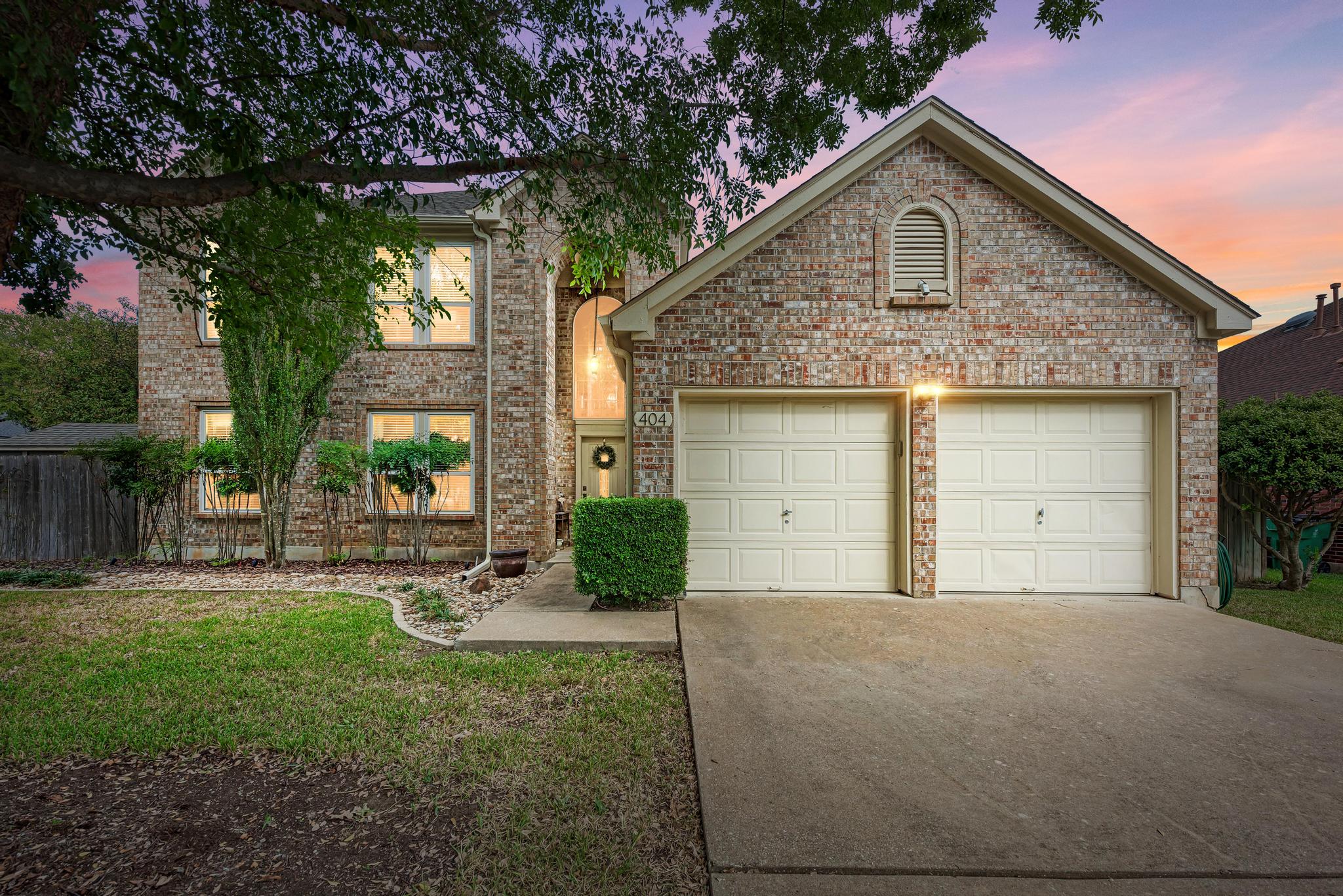 404 Cripple Creek Road Cedar Park, TX 78613 - Photo 2 of 39 a front view of a house with garden