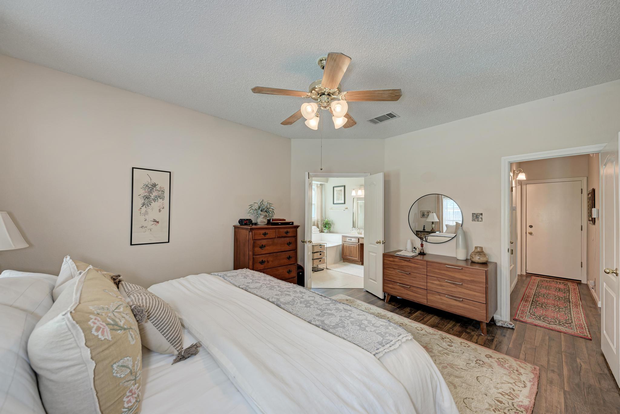 404 Cripple Creek Road Cedar Park, TX 78613 - Photo 24 of 39 a bedroom with a bed and a chandelier