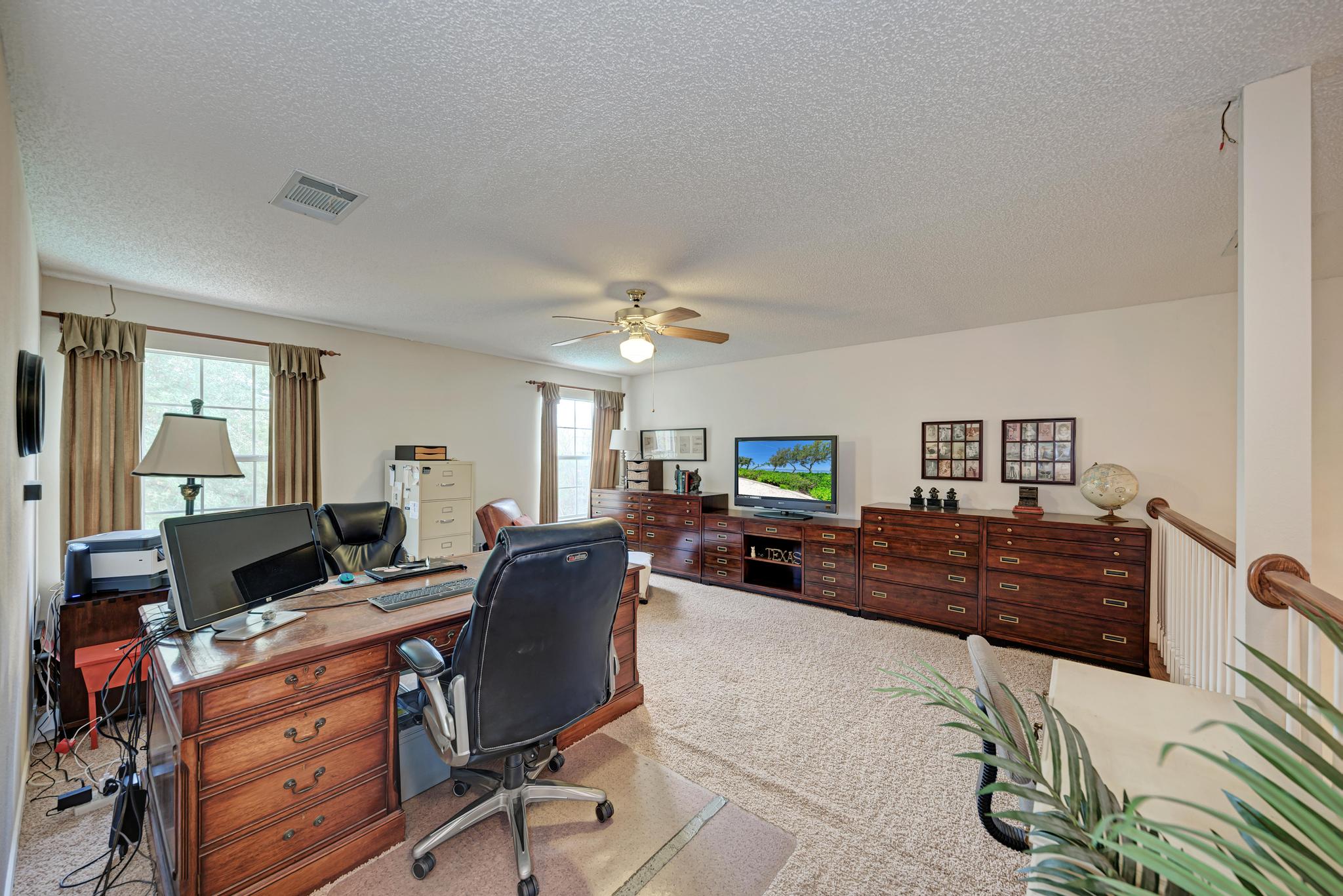 404 Cripple Creek Road Cedar Park, TX 78613 - Photo 28 of 39 a view of a workspace with furniture and a window