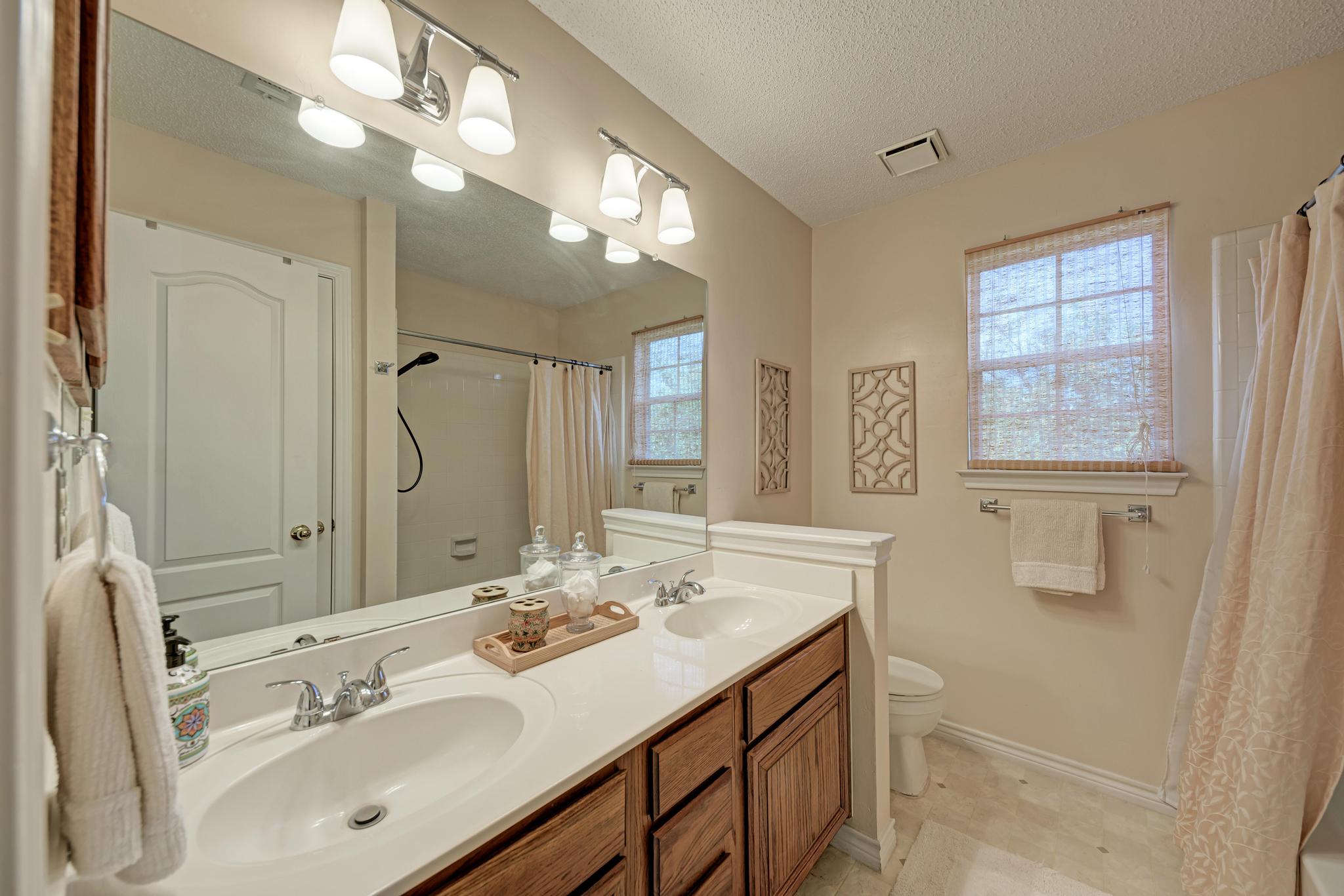 404 Cripple Creek Road Cedar Park, TX 78613 - Photo 35 of 39 a bathroom with a sink double vanity granite tub and a mirror