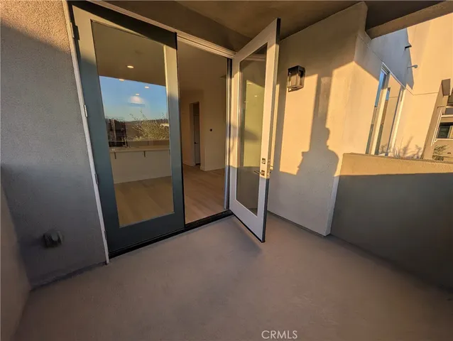 a view of kitchen and hall with wooden floor