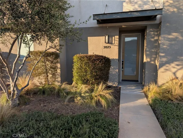 a kitchen with kitchen island stainless steel appliances a sink stove refrigerator and cabinets
