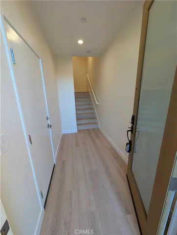 a large white room with wooden floor