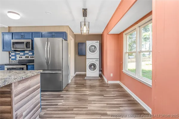 a front view of house with yard slide and large tree