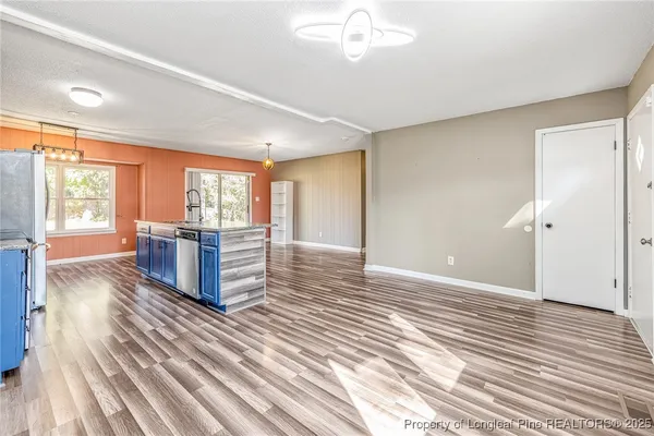a living room with a furniture and a large window
