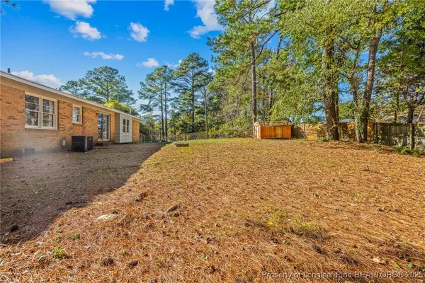 a view of house with backyard