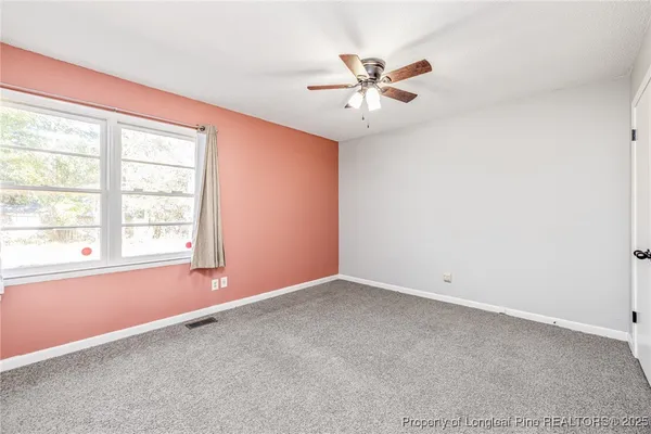 a view of a room with wooden floor and window
