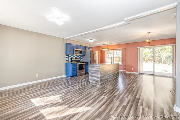 a view of a kitchen with a sink cabinets and wooden floor