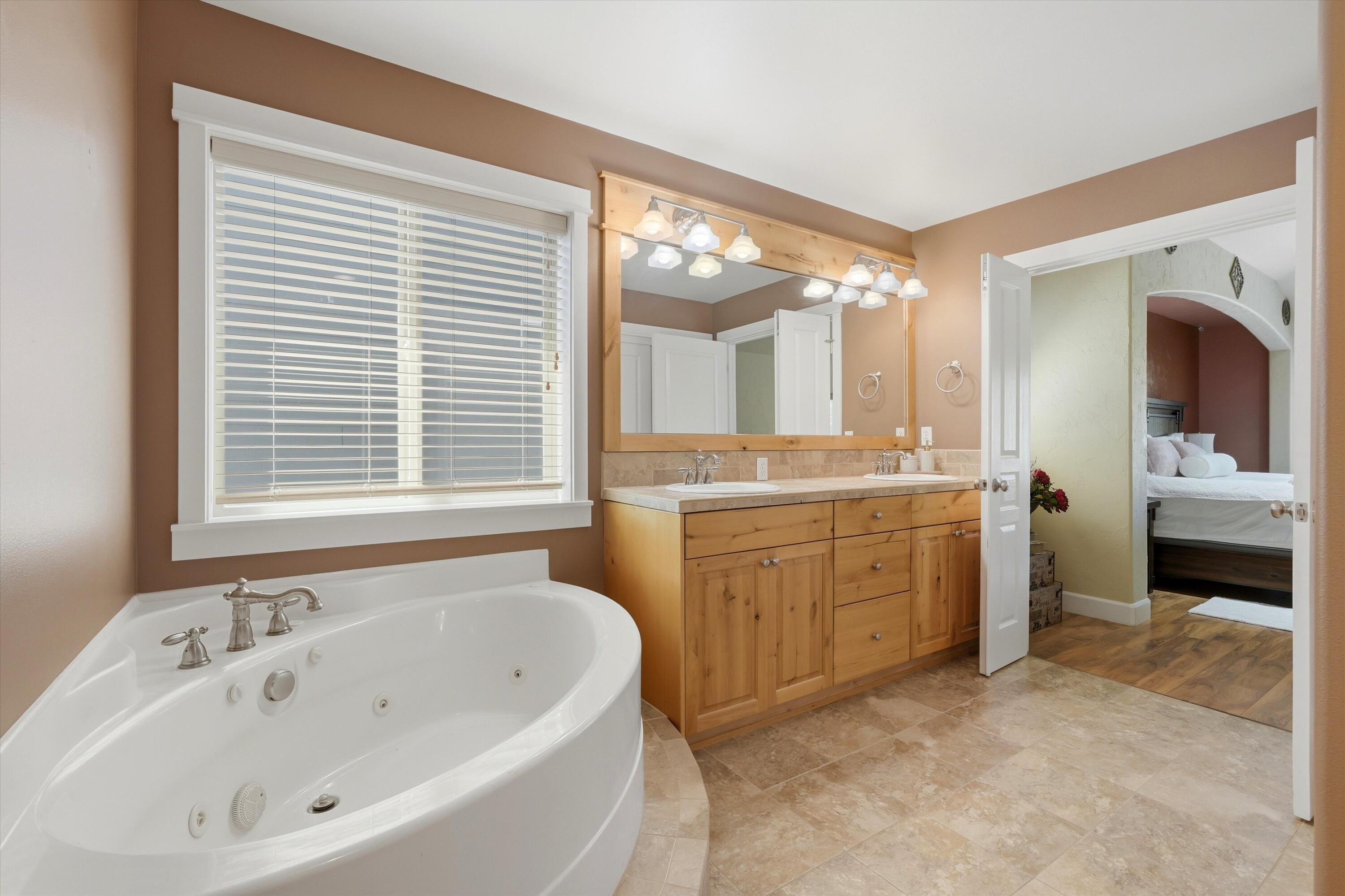 61235 Splendor Lane Bend, OR 97702 - Photo 41 of 52 Spacious and relaxing jetted tub, with dual vanities and separate shower, and enclosed water closet
