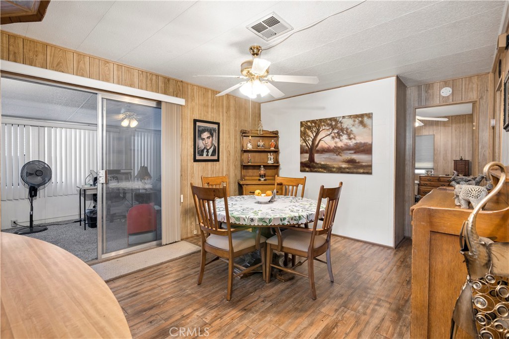 2230 Lake Park Drive, Unit 170 San Jacinto, CA 92583 - Photo 15 of 40 a view of a dining room with furniture a chandelier and wooden floor