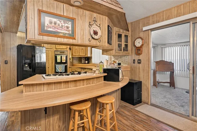 a kitchen with stainless steel appliances granite countertop a stove and cabinets