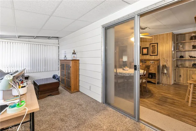 a living room with furniture and a floor to ceiling window