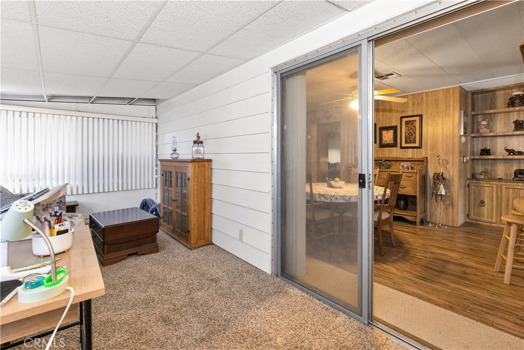 2230 Lake Park Drive, Unit 170 San Jacinto, CA 92583 - Photo 19 of 40 a living room with furniture and a floor to ceiling window
