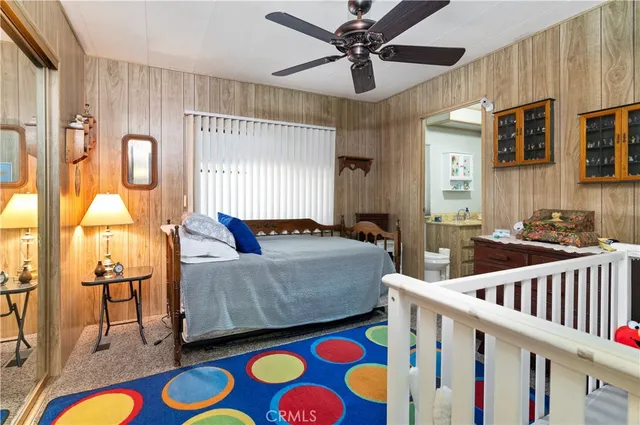 a living room with furniture and a baby crib