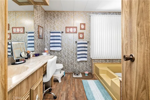 a bathroom with a sink a bathtub and a window