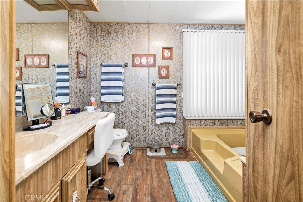 2230 Lake Park Drive, Unit 170 San Jacinto, CA 92583 - Photo 26 of 40 a bathroom with a sink a bathtub and a window