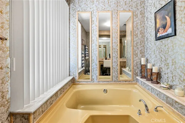 a bath tub sitting next to a bathroom sink
