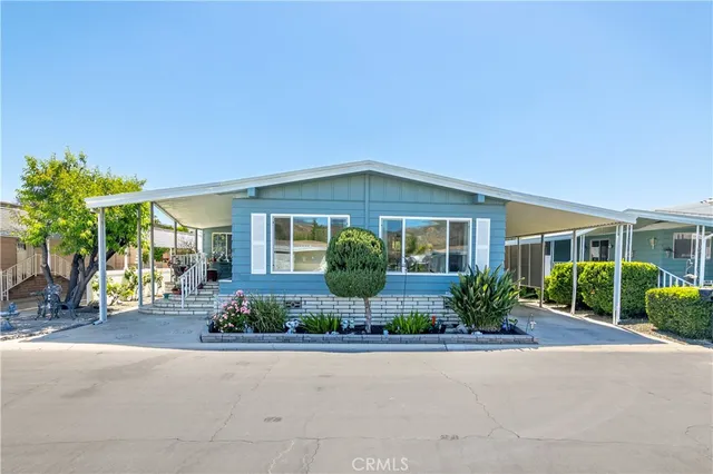 front view of a house with a bench and a yard