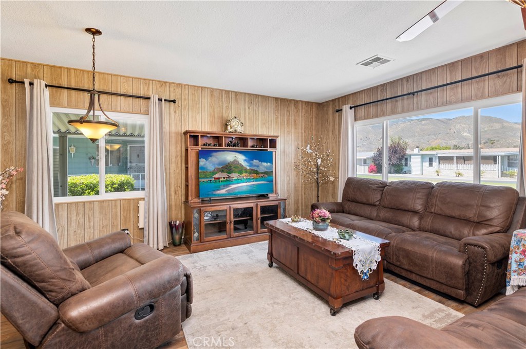 2230 Lake Park Drive, Unit 170 San Jacinto, CA 92583 - Photo 10 of 40 a living room with furniture a large window and a flat screen tv