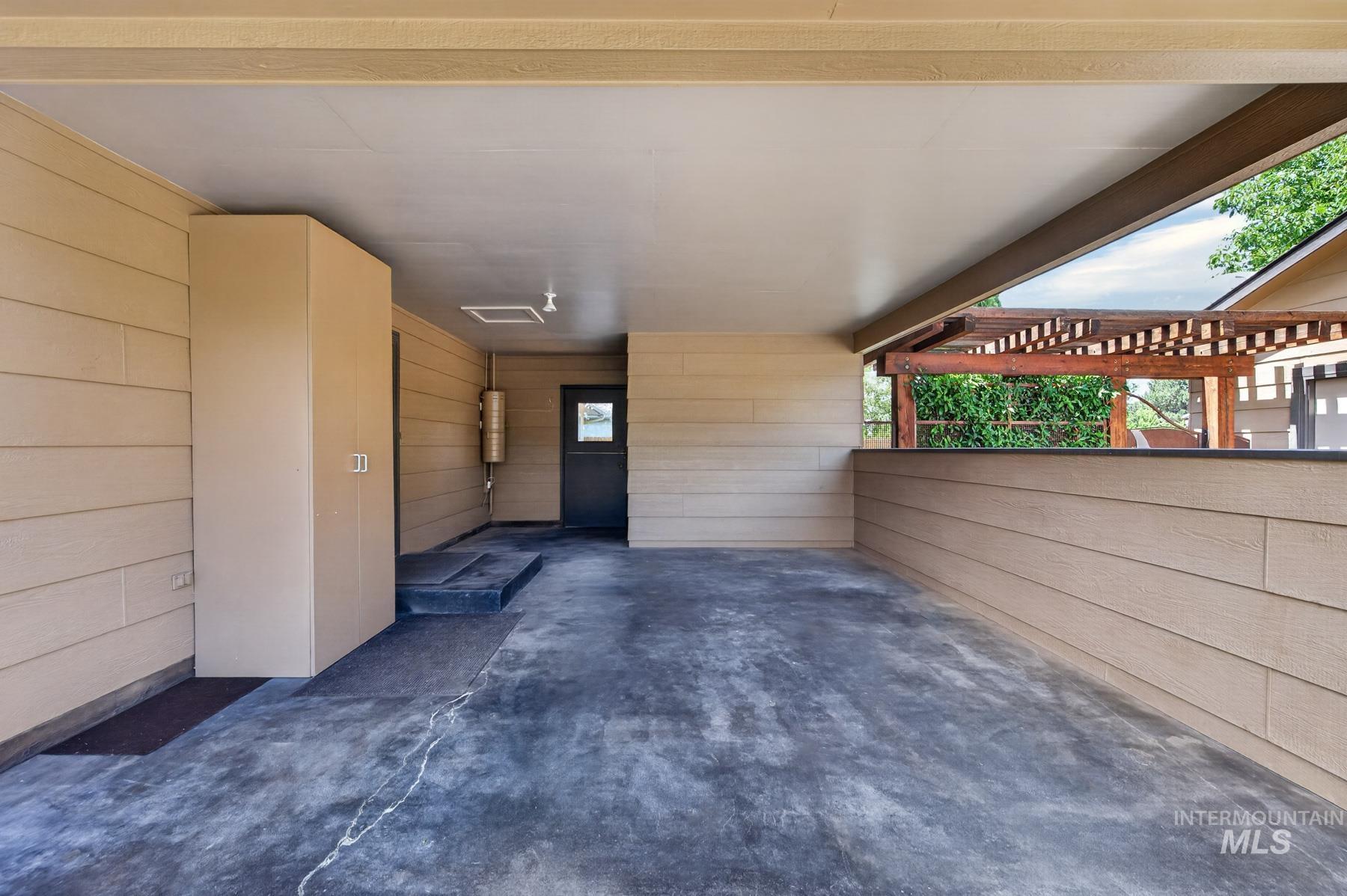 9622 Delaware Street Boise, ID 83709 - Photo 45 of 48 Covered concrete patio featuring horizontal panel siding, a built-in storage cabinet, and an exterior door