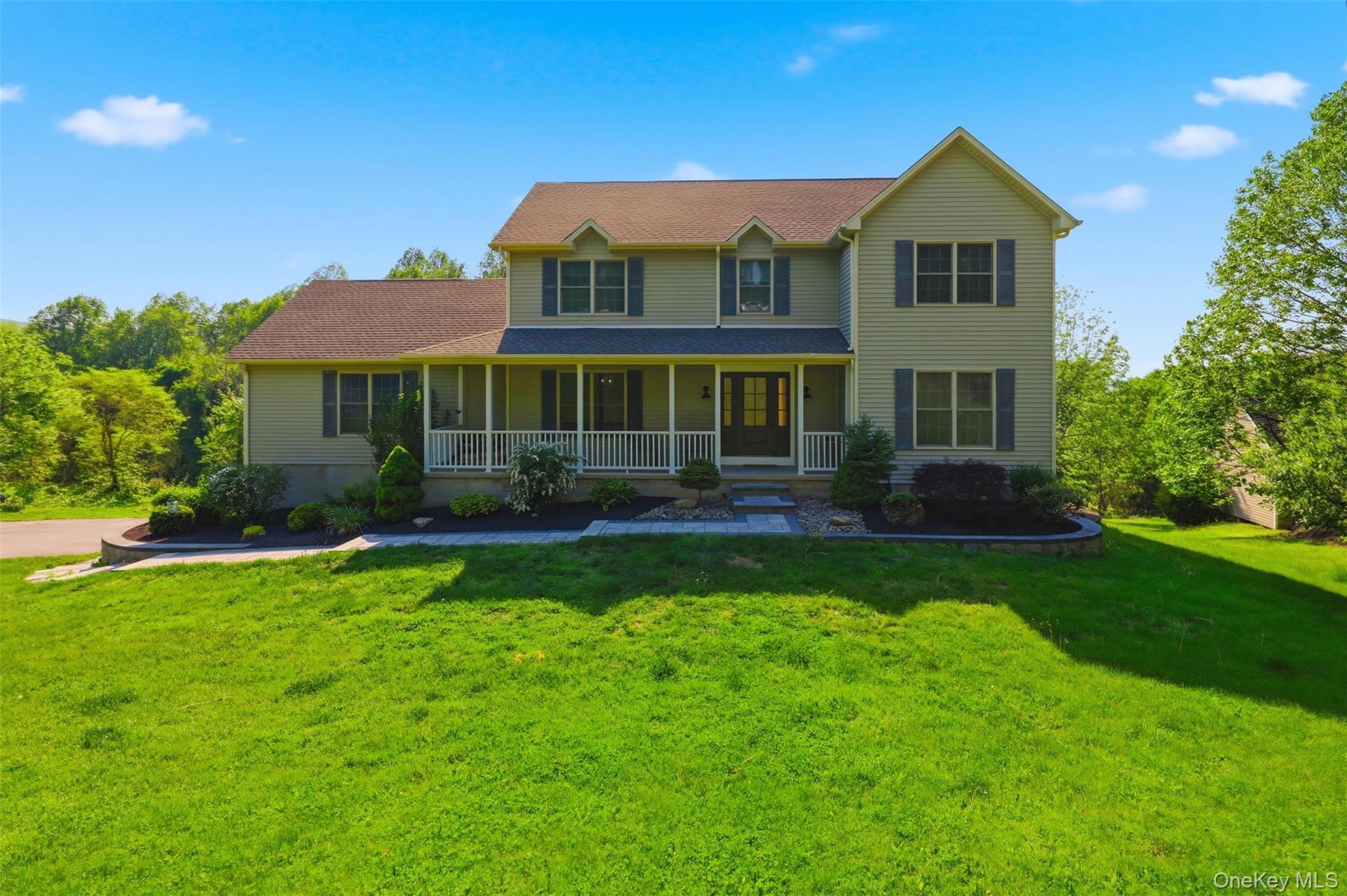 233 Devon Farms Road Stormville, NY 12582 - Photo 1 of 48 a front view of a house with a yard and potted plants