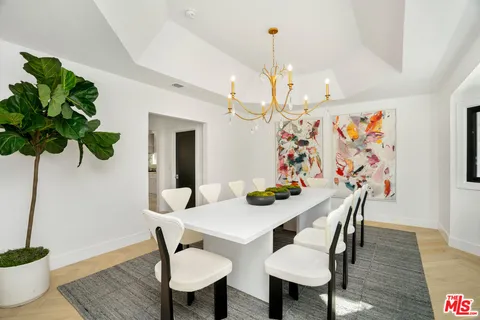 a large white kitchen with a large window