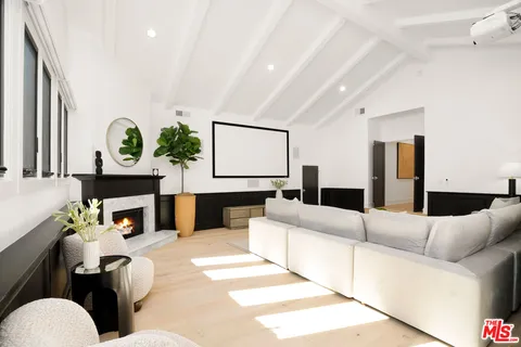 a living room with furniture a table and chairs