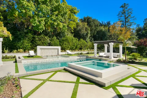 a view of a patio with couches table and chairs and potted plants