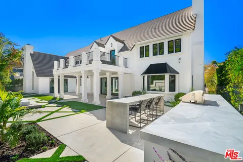 a house view with a sitting space and garden space