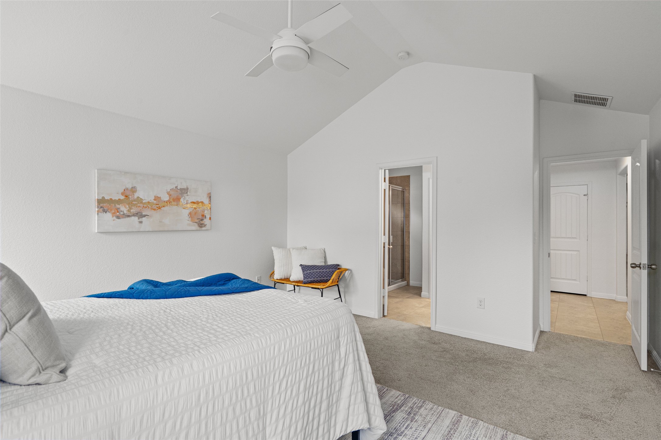 705 Schefer Street Leander, TX 78641 - Photo 16 of 26 a bedroom with a large bed and a chandelier