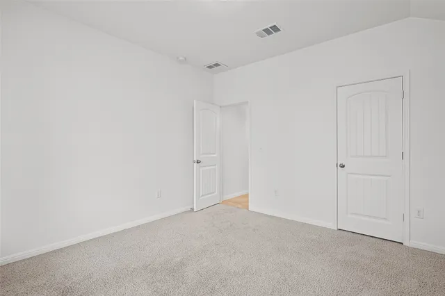 a bathroom with a granite countertop sink toilet and a mirror