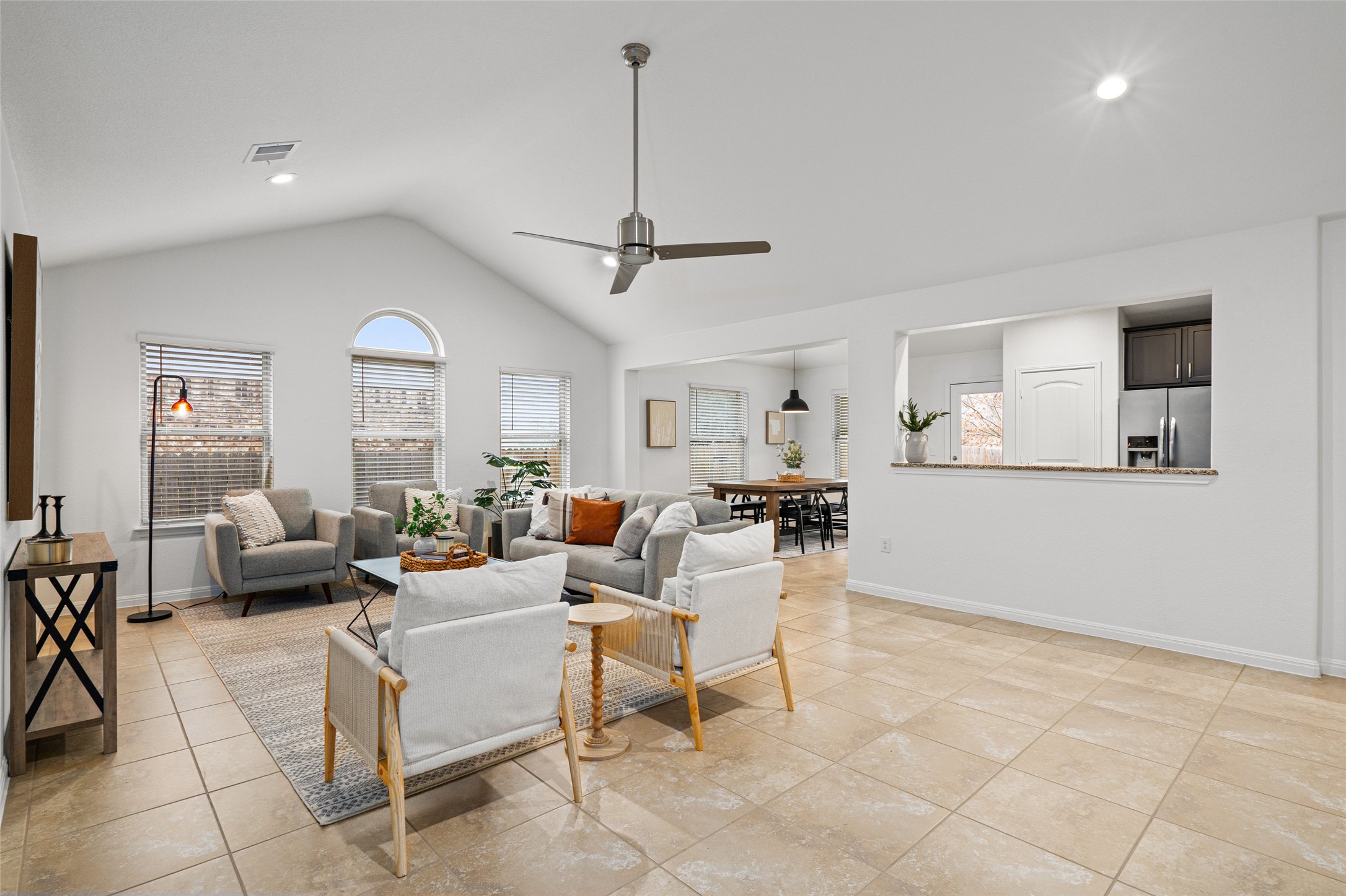 705 Schefer Street Leander, TX 78641 - Photo 5 of 26 a living room with lots of furniture and a ceiling fan