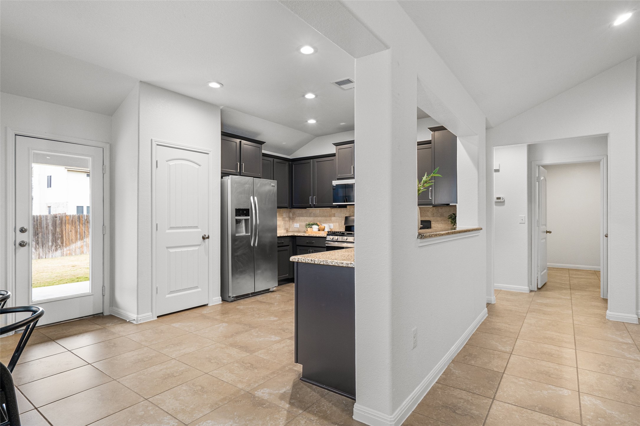 705 Schefer Street Leander, TX 78641 - Photo 10 of 26 a view of a kitchen with refrigerator and a sink