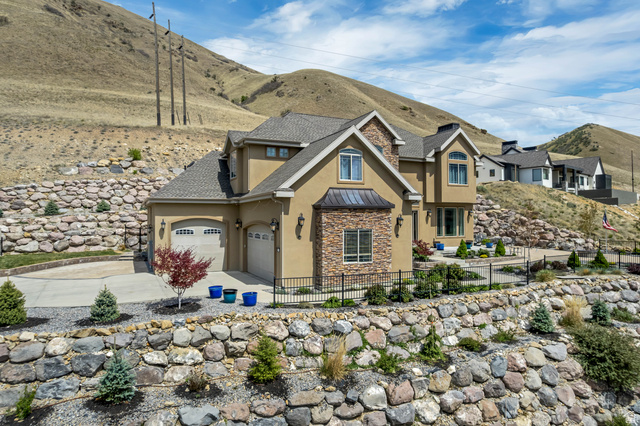 2543 East 700 South Springville, UT 84663 - Photo 2 of 73 Craftsman house featuring stucco siding, stone siding, a fenced front yard, a standing seam roof, and roof with shingles