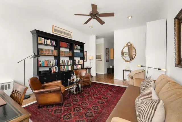 a living room with furniture or couch and a bookshelf