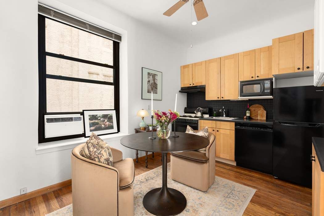 51 West 81st Street, Unit 5A Manhattan, NY 10024 - Photo 7 of 16 a kitchen with granite countertop a stove a sink and a refrigerator