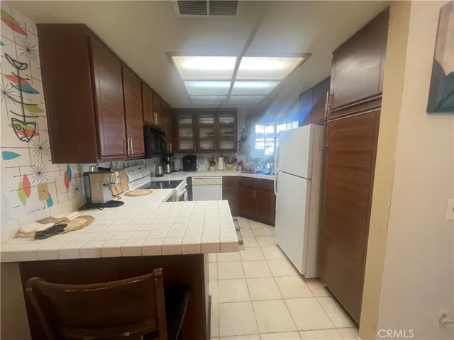 a kitchen with a refrigerator sink and stove