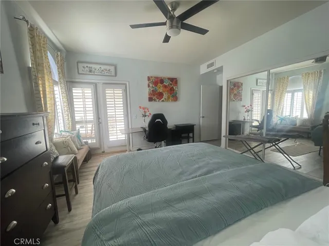 a bed room with a bed a couch and a large window