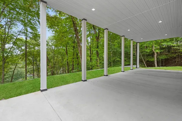 an aerial view of lake residential house with outdoor space and trees around