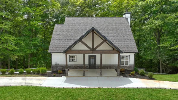an aerial view of a house with a yard basket ball court and outdoor seating
