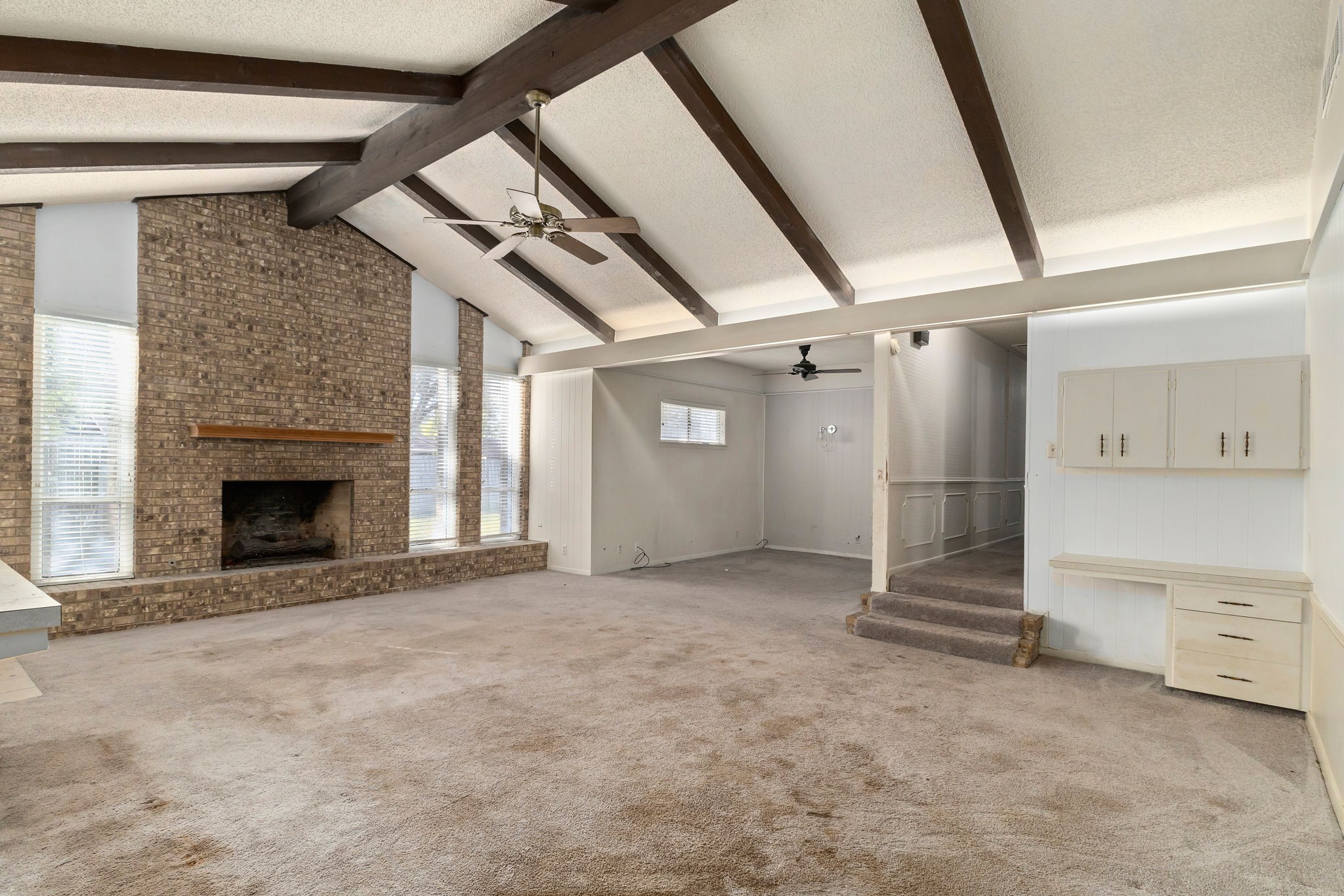 202 Kallus Street Schulenburg, TX 78956 - Photo 12 of 36 a view of an empty room with a fireplace and a window