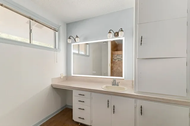 a bathroom with a sink and a window