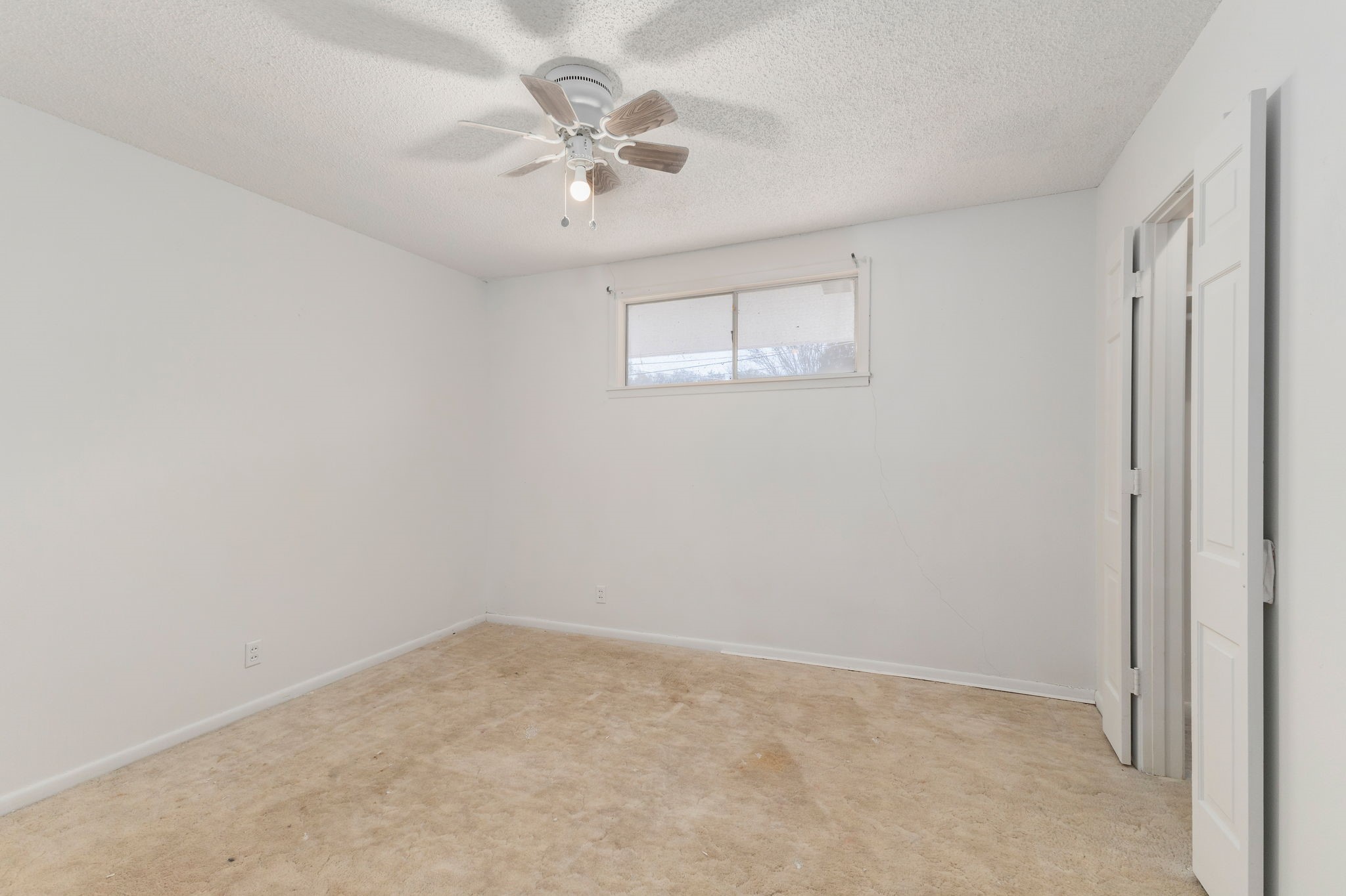 202 Kallus Street Schulenburg, TX 78956 - Photo 23 of 36 an empty room with a chandelier fan