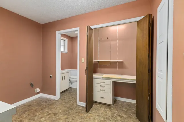 a white toilet sitting next to a bathroom sink