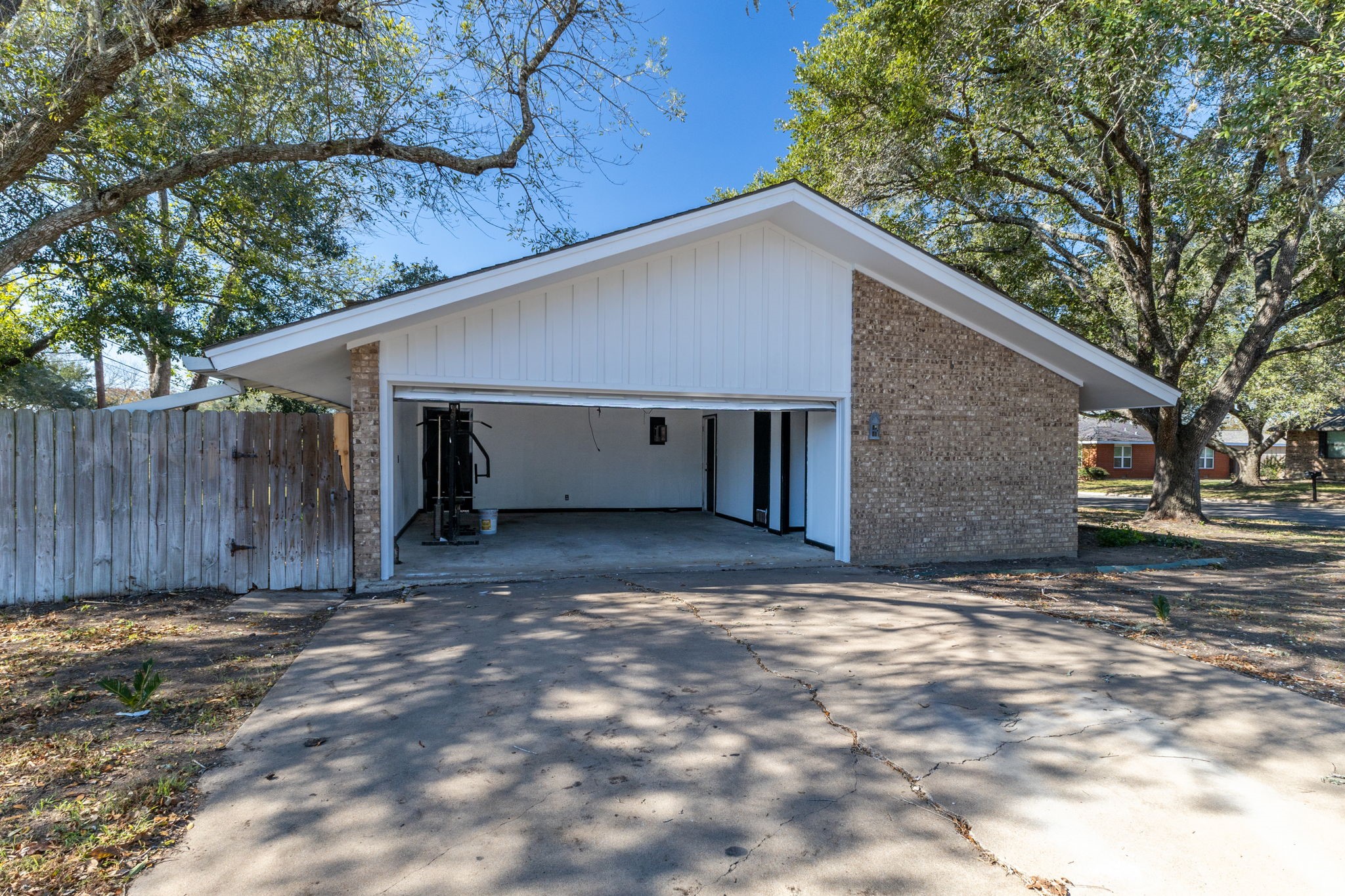 202 Kallus Street Schulenburg, TX 78956 - Photo 30 of 36 a view of a house with a garage and large tree