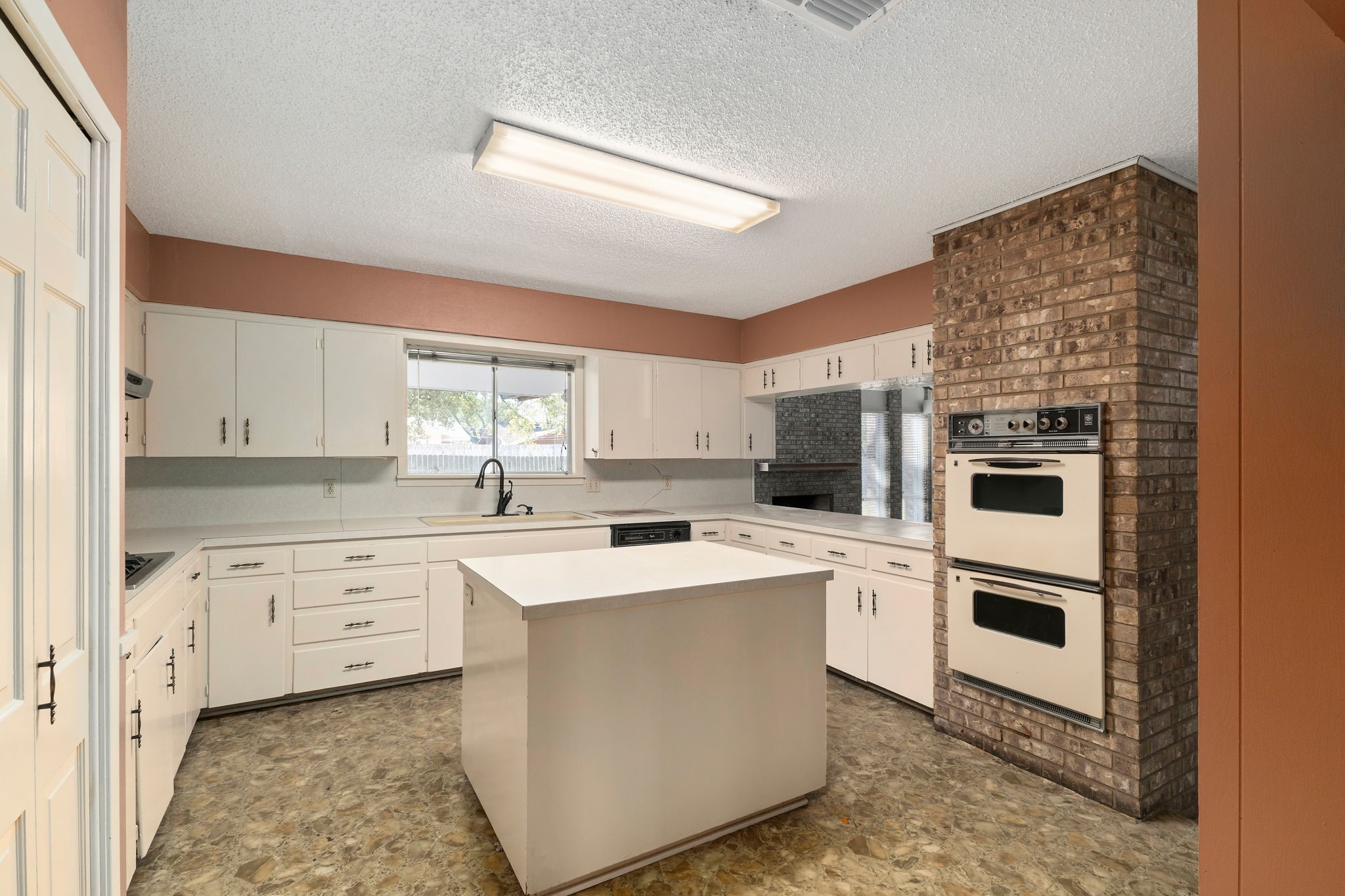 202 Kallus Street Schulenburg, TX 78956 - Photo 9 of 36 a kitchen with white cabinets and white appliances