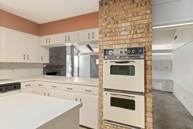 a kitchen with a stove and a refrigerator