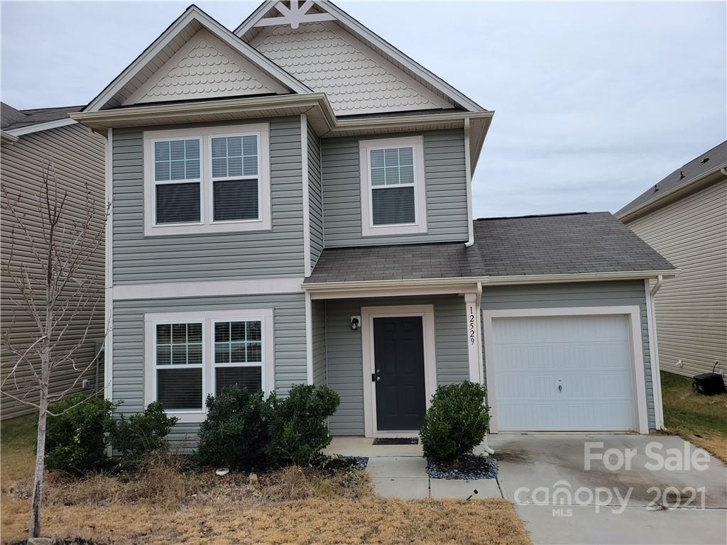 a front view of a house with yard