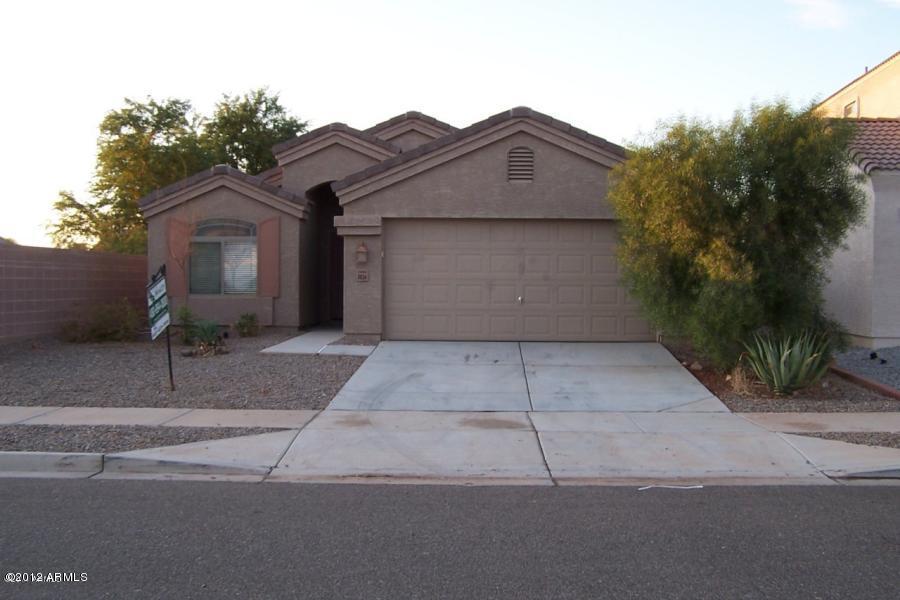 8634 West Riley Road Tolleson, AZ 85353 - Photo 1 of 12 a view of a house with a yard and large tree