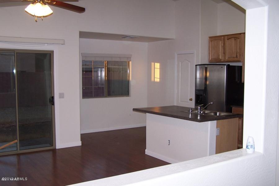 8634 West Riley Road Tolleson, AZ 85353 - Photo 4 of 12 a kitchen with stainless steel appliances granite countertop a refrigerator and a stove